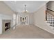 Bright living room with a fireplace, chandelier, and french doors to the outdoors at 268 Wraggs Ferry Rd., Georgetown, SC 29440