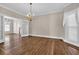 Open living room with hardwood floors, a chandelier, and french doors at 268 Wraggs Ferry Rd., Georgetown, SC 29440