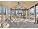 Covered porch with wood flooring and screens all around to protect from the elements at 268 Wraggs Ferry Rd., Georgetown, SC 29440