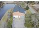 Aerial view of a brick home with a pond, detached garage and long driveway at 300 19Th Ave. S, Myrtle Beach, SC 29577