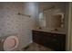 Bathroom featuring dual sinks, wallpaper, and a toilet at 300 19Th Ave. S, Myrtle Beach, SC 29577