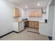 Basement kitchenette with white appliances and light wood cabinets at 300 19Th Ave. S, Myrtle Beach, SC 29577