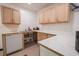 Basement kitchenette featuring a dishwasher, double sink and wood cabinets at 300 19Th Ave. S, Myrtle Beach, SC 29577