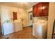 Bright laundry room featuring two washers, a dryer, and ample cabinet storage at 300 19Th Ave. S, Myrtle Beach, SC 29577