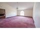 Living room area with a large window and outdated carpet at 300 19Th Ave. S, Myrtle Beach, SC 29577