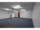 Spacious room featuring blue carpet, white refrigerator and door to hallway at 300 19Th Ave. S, Myrtle Beach, SC 29577