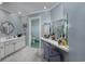 Bright bathroom featuring a vanity with ample counter space, patterned wallpaper in the toilet, and a blue accent wall at 304 Queens Rd., Myrtle Beach, SC 29572