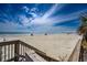 Expansive beach view with clear skies, ocean view, and the coastline with dunes and vegetation at 304 Queens Rd., Myrtle Beach, SC 29572