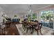 Elegant dining area with hardwood floors, chandelier, and large windows offering backyard views at 304 Queens Rd., Myrtle Beach, SC 29572