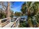 Scenic view of a dock leading to a calm lake surrounded by lush greenery and a serene atmosphere at 304 Queens Rd., Myrtle Beach, SC 29572