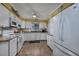 Well-lit kitchen with white cabinets, modern appliances, and tile flooring, offering a clean and functional space at 304 Queens Rd., Myrtle Beach, SC 29572