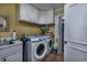 Efficient laundry room with a sink, modern washer and dryer, and ample storage space at 304 Queens Rd., Myrtle Beach, SC 29572