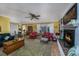 Cozy living room with a fireplace, comfortable seating, an elegant rug, and an open dining area at 304 Queens Rd., Myrtle Beach, SC 29572