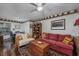 Inviting living room featuring wood floors, a red sofa, patterned pillows, and a trunk-style coffee table at 304 Queens Rd., Myrtle Beach, SC 29572