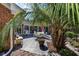 Outdoor patio area featuring comfortable seating, a dining table, and lush landscaping at 304 Queens Rd., Myrtle Beach, SC 29572