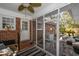 Inviting screened-in porch with brick accents, ceiling fan, and access to a charming brick-paved backyard at 304 Queens Rd., Myrtle Beach, SC 29572