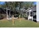 Serene backyard featuring a lush lawn, a hammock, and an outdoor grill at 306 Oak Lake Circle, North Myrtle Beach, SC 29582