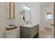 Modern bathroom featuring a vanity with fixtures, storage and a view into the kitchen at 306 Oak Lake Circle, North Myrtle Beach, SC 29582