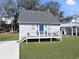 Charming beach house with a cozy front porch, steps, and lush green lawn at 306 Oak Lake Circle, North Myrtle Beach, SC 29582