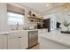 Bright kitchen featuring a farmhouse sink, white countertops, and stainless steel appliances at 306 Oak Lake Circle, North Myrtle Beach, SC 29582