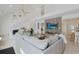 Open living room featuring vaulted ceilings, white staircase, and an accent wall with a TV at 306 Oak Lake Circle, North Myrtle Beach, SC 29582