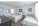 Bright bedroom with two beds, wood-look floors, and calming artwork at 314 58Th Ave. N, North Myrtle Beach, SC 29582