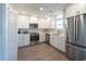 Well-lit kitchen featuring stainless steel appliances, white cabinetry, and tile backsplash at 314 58Th Ave. N, North Myrtle Beach, SC 29582