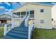 Exterior of elevated home featuring stairs leading to a screened porch and well-maintained lawn at 314 58Th Ave. N, North Myrtle Beach, SC 29582