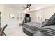 Comfortable bedroom with a ceiling fan, grey bedding, and natural light from the shuttered windows at 323 45Th Ave. N, North Myrtle Beach, SC 29582