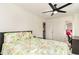 Bright bedroom with a ceiling fan, a floral comforter, and natural light from the shuttered windows at 323 45Th Ave. N, North Myrtle Beach, SC 29582