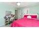 Cozy bedroom with a white ceiling fan, light green walls, and a pink bed set, providing a bright, comfortable space at 323 45Th Ave. N, North Myrtle Beach, SC 29582