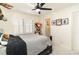 Bedroom with a ceiling fan, grey bedding, and natural light from the shuttered windows at 323 45Th Ave. N, North Myrtle Beach, SC 29582