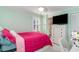 Bedroom with a ceiling fan, pink bedding, and natural light from the shuttered windows at 323 45Th Ave. N, North Myrtle Beach, SC 29582