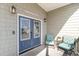 Inviting front porch with seating and stylish double doors with decorative etched glass at 323 45Th Ave. N, North Myrtle Beach, SC 29582