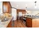 Spacious kitchen featuring wood cabinetry, granite countertops, stainless appliances, and an eat-in island at 323 45Th Ave. N, North Myrtle Beach, SC 29582