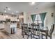 Bright dining area adjacent to a modern kitchen featuring stainless steel appliances and ample counter space at 325 High Falls Dr., Conway, SC 29526