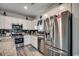 Well-lit kitchen features stainless steel appliances, granite countertops, and white cabinets at 325 High Falls Dr., Conway, SC 29526