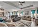 Open-concept living room featuring wood-look floors, comfortable seating, and a modern ceiling fan at 325 High Falls Dr., Conway, SC 29526