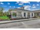 Community pool house features a covered entry, dark shutters, flower beds, and black iron fence at 325 High Falls Dr., Conway, SC 29526