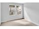 Bare bedroom with neutral carpet features two windows and a view of the neighborhood at 327 Sandridgebury Dr. # 72, Little River, SC 29566