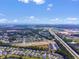 A wide aerial shot captures a vast residential area near a highway and distant cityscape at 331 Sandridgebury Dr. # 74, Little River, SC 29566