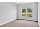 Bedroom with soft carpeting and a bright window offering backyard views at 331 Sandridgebury Dr. # 74, Little River, SC 29566