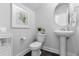 Cozy half bathroom with pedestal sink and minimalist decor at 335 Sandridgebury Dr. # 75, Little River, SC 29566