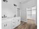 Bright bathroom featuring double vanity with white cabinetry and a spacious walk-in closet with custom shelving at 3372 Gurley Rd., Loris, SC 29569