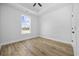 Bright bedroom featuring a large window, modern flooring, and neutral walls for a comfortable living space at 3372 Gurley Rd., Loris, SC 29569