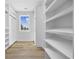 Well-organized walk-in closet with custom shelving, natural light and a modern design for optimized storage at 3372 Gurley Rd., Loris, SC 29569