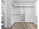 A large walk-in closet featuring custom shelving and storage options, as well as modern laminate flooring at 3372 Gurley Rd., Loris, SC 29569