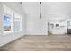 Bright living room with large windows and wainscoting detail flows into kitchen and dining area at 3372 Gurley Rd., Loris, SC 29569