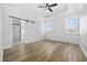 Spacious main bedroom featuring a tray ceiling, ceiling fan, and a barn door leading to the bathroom at 3372 Gurley Rd., Loris, SC 29569