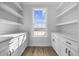 Functional pantry space featuring ample cabinet storage with white cabinets, dark hardware, and a large window at 3372 Gurley Rd., Loris, SC 29569